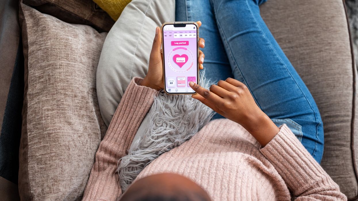 A woman using a period tracker app