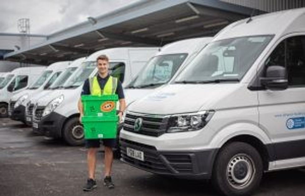 Alliance Healthcare UK driver stacking totes outside van 2