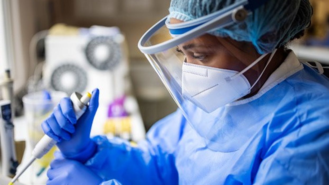 Scientists examining pathogens in a lab