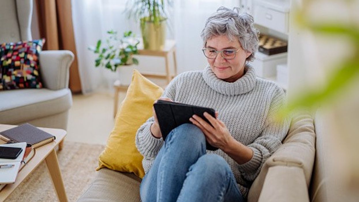 Smiling senior woman using tablet at home